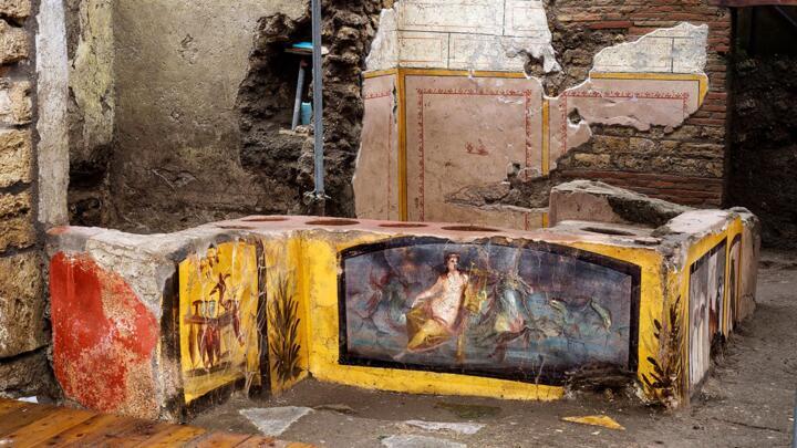 This picture released on December 26, 2020 by the Pompeii Press Office shows a thermopolium, a sort of street "fast-food" counter in ancient Rome, that has been unearthed in Pompeii, decorated with polychrome motifs and in an exceptional state of preservation. The counter, frozen by volcanic ash, had been partly unearthed in 2019 but the work was extended to best preserve the entire site, located at the crossroads of rue des Noces d'Argent and rue des Balcons.